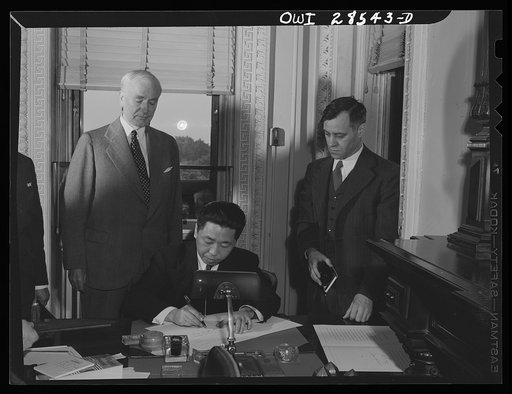 Secretary of State Cordell Hull and Chinese Ambassador Wei Tao-Ming at the State Department exchanging ratifications of the treaty abolishing extra-territorial "rights" of the United States in China.  The treaty provided that it becomes effective at the time of this exchange