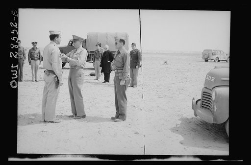 An Allied airbase somewhere in North Africa. Leroy H. Woods, 1381 Worton Boulevard, Cleveland, Ohio, pilot of a B-25 Bonber as he received his air medal for gallentry under fire at El Alamein from General Auby C. Strickland