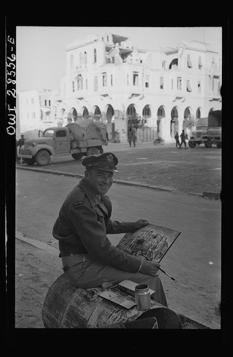 Lieutenant Milton Marx of New York City, attached to the Public Relations Office of the United States Army Ninth Air Force, does some painting in the streets of Tripoli. In civilian life Marx is a commercial artist