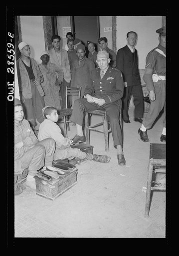 Brigade Genera Auby C. Strickland of the United States Army Ninth Air Force gets his shoes shined in Tripoli