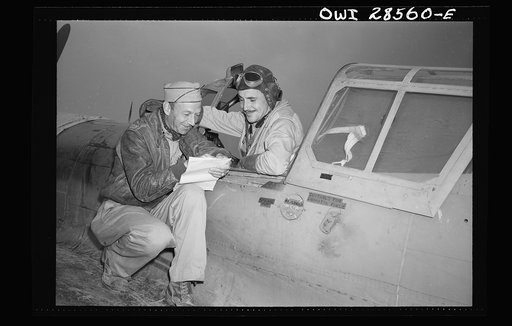 Lieutenant Robert "Rocky" Byrnes (in the plane), twenty-six, Saint Louis, Missouri, flying with the Sixty-fourth Squadron of the Fifty-seventy Fighter Group is seen here as he landed after destroying three ME-109's. The Fifty-seventh United States Fighter Group of the Ninth Air Force destroyed seven