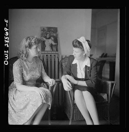 Washington, D.C. Two blood donors talking it over after having given a pint of blood. Note how girl on right holds cotton pad on her arm where needle was injected