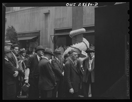 New York, New York. Spectators attracted by the exhibits at the Nature of the Enemy show, put up by the United States OWI (Office of War Information) at Rockefeller Plaza