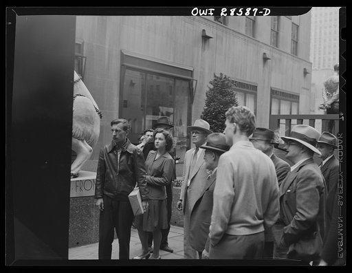 New York, New York. Spectators attracted by the exhibits at the Nature of the Enemy show, put up by the United States OWI (Office of War Information) at Rockefeller Plaza