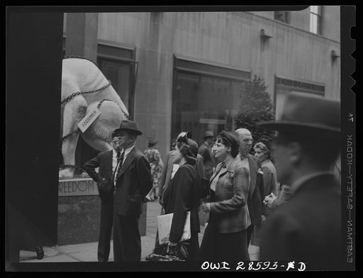 New York, New York. Spectators attracted by the exhibits at the Nature of the Enemy show, put up by the United States OWI (Office of War Information) at Rockefeller Plaza
