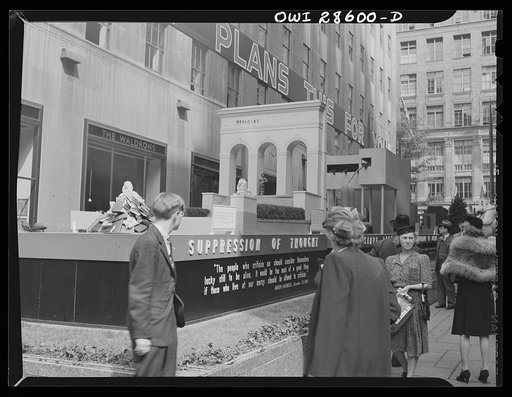 New York, New York. Spectators attracted by the exhibits at the Nature of the Enemy show, put up by the United States (Office of War Information) at Rockefeller Plaza