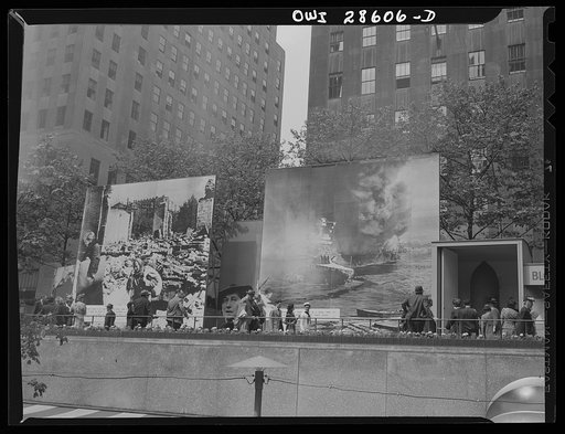 New York, New York. Spectators attracted by the exhibits at the Nature of the Enemy show, put up by the United States OWI (Office of War Information) at Rockefeller Plaza