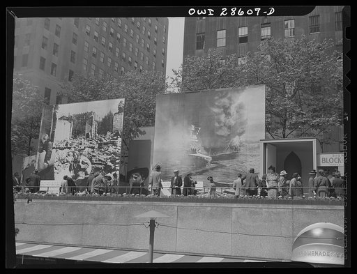 New York, New York. Spectators attracted by the exhibits at the Nature of the Enemy show, put up by the United States OWI (Office of War Information) at Rockefeller Plaza
