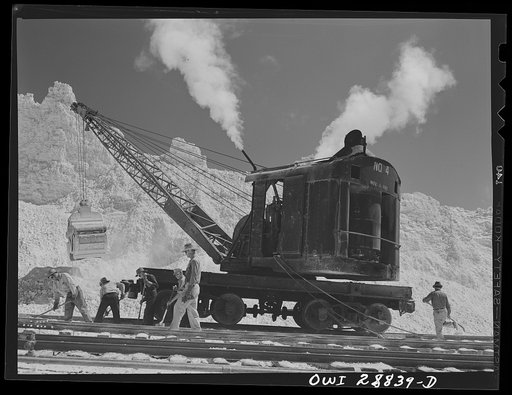 Freeport Sulphur Company, Hoskins Mound, Texas. Cleaning sulphur off railroad tracks after blasting