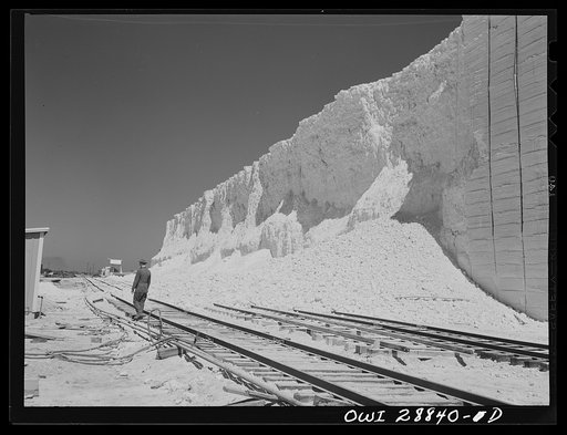Untitled photo, possibly related to: Freeport Sulphur Company, Hoskins Mound, Texas. Loading boxcars with sulphur