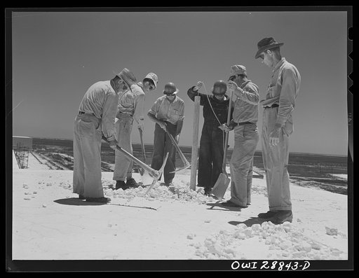 Freeport Sulphur Company, Hoskins Mound, Texas. Lowering dynamite into hole preparatory to blasting from top of vat