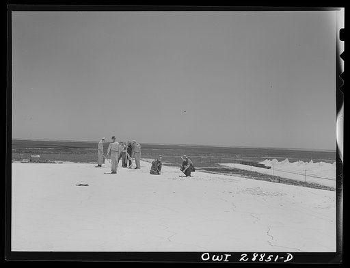 Untitled photo, possibly related to: Freeport Sulphur Company, Hoskins Mound, Texas. Lowering dynamite into hole preparatory to blasting from top of vat