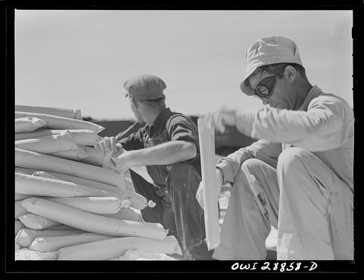 Untitled photo, possibly related to: Freeport Sulphur Company, Hoskins Mound, Texas. Loading dynamite charges preparatory to blasting
