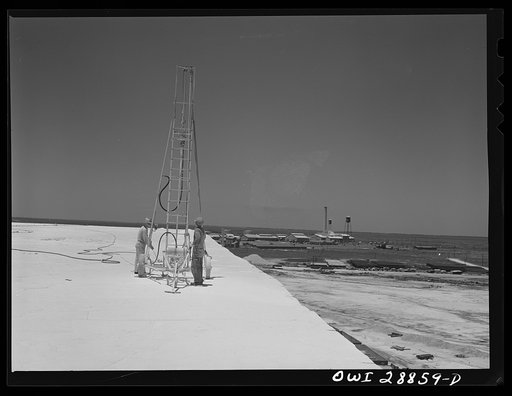Freeport Sulphur Company, Hoskins Mound, Texas. Blasting crew drilling a hole on the top of a sulphur vat preparatory to blasting it