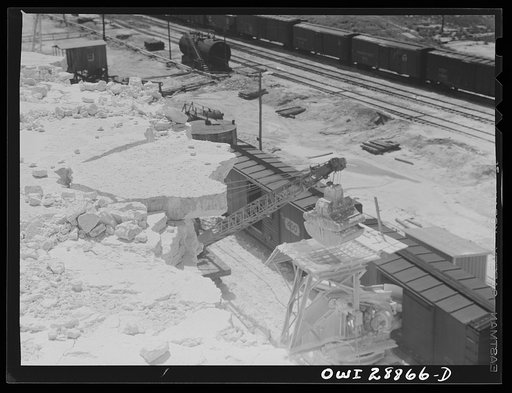 Freeport Sulphur Company, Hoskins Mound, Texas. Loading boxcars with sulphur after blasting