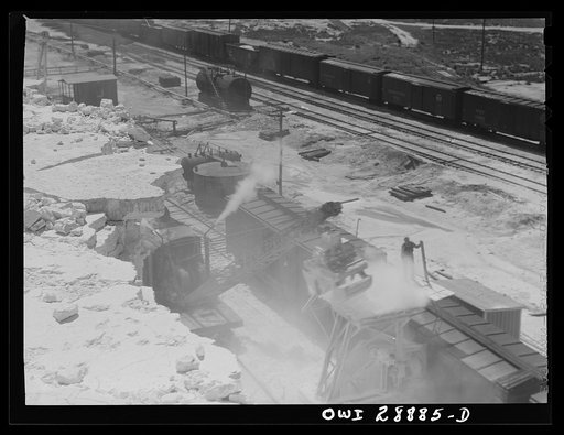 Freeport Sulphur Company, Hoskins Mound, Texas. Loading boxcars with sulphur after blasting a vat