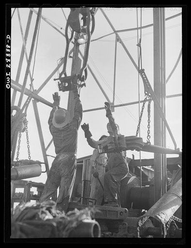 Untitled photo, possibly related to: Freeport Sulphur Company, Hoskins Mound, Texas. Pulling up a pipe at a sulphur well