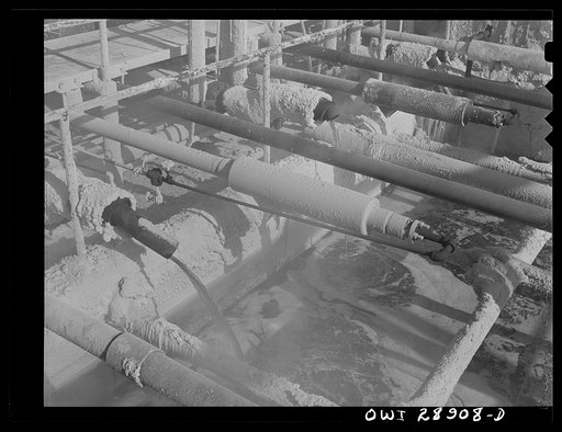 Untitled photo, possibly related to: Freeport Sulphur Company, Hoskins Mound, Texas. Molten sulphur pouring into a tank at relay station
