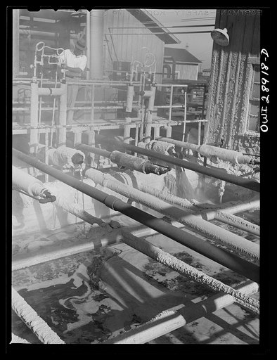 Untitled photo, possibly related to: Freeport Sulphur Company, Hoskins Mound, Texas. Molten sulphur pouring into a tank at a relay station