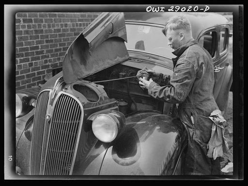 A man repairing his automobile. Silver Spring, Maryland