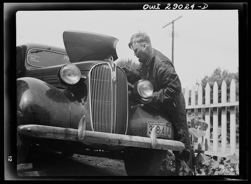 Untitled photo, possibly related to: A man repairing his automobile. Silver Spring, Maryland