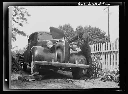 Untitled photo, possibly related to: A man repairing his automobile. Silver Spring, Maryland