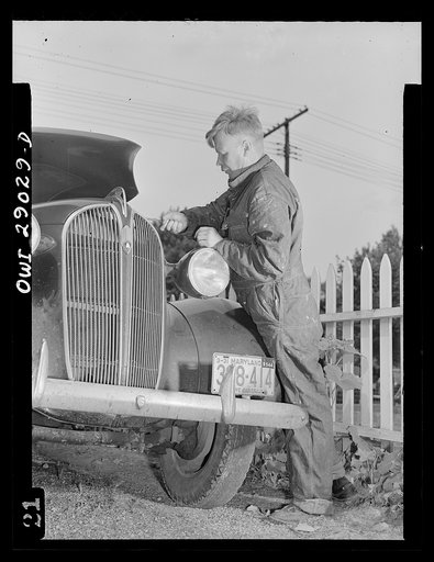 A man repairing his automobile. Silver Spring, Maryland