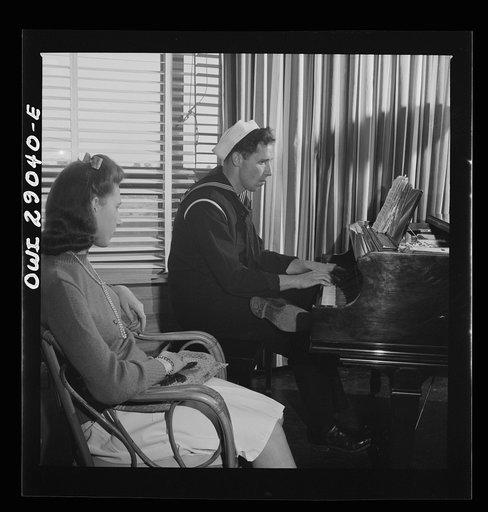 Untitled photo, possibly related to: Arlington, Virginia. A group around a piano in the lounge of Idaho Hall, Arlington Farms, a residence for women who work in the United States government for the duration of the war