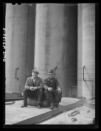 Scoopers on a grain boat from Deluth unloading at a grain elevator on the Erie Canal. Buffalo, New York