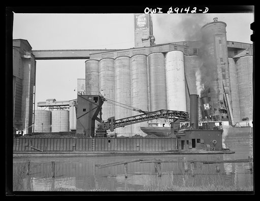 Untitled photo, possibly related to: Buffalo, New York. Grain elevators and coal barge