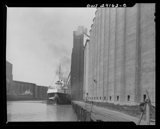 Buffalo, New York. Grain boat from Deluth unloading wheat at a grain elevator on the Erie Canal