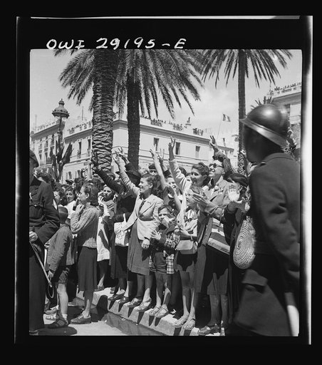 Cheering women and children line the streets to cheer the Allied armies as they march through Tunis