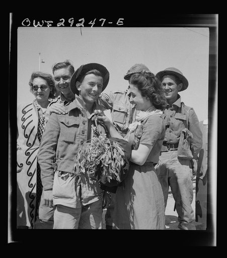 Tunis, Tunisia. A young woman pinning a flower on the coat lapel of a British soldier who entered Tunis with the Allied armies