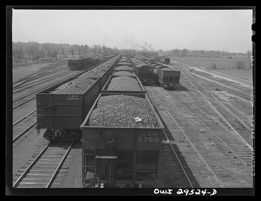 Untitled photo, possibly related to: Sandusky, Ohio. Looking across the Pennsylvania Railroad docks from number one dock to number three dock. In the background, a switch engine is bringing in a trainload of coal