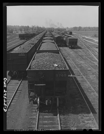 Untitled photo, possibly related to: Sandusky, Ohio. Looking across the Pennsylvania Railroad docks from number one dock to number three dock. In the background, a switch engine is bringing in a trainload of coal