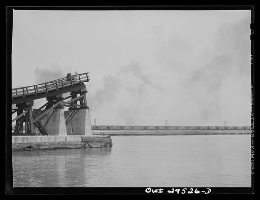 Untitled photo, possibly related to: Sandusky, Ohio. The kick-back trestle of the Pennsylvania Railroad number two dock. In the distance, a switch engine that has just delivered a trainload of coal, is going back to the storage yard for more