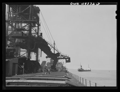 Sandusky, Ohio. Loading coal from the Pennsylvania Railroad docks into a lake freighter. In the distance, a boat that has just been loaded is leaving port