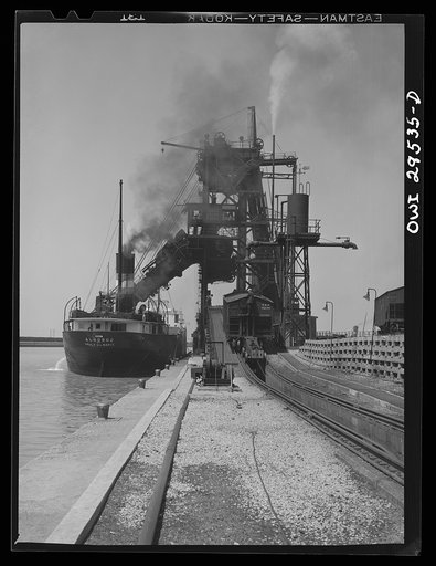 Sandusky, Ohio. Loading coal into a lake freighter at the Pennsylvania Railroad docks. A "pig" is pushing a coal car up the incline to the loading machine