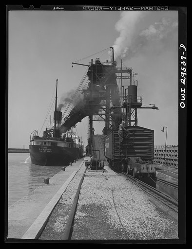 Sandusky, Ohio. Loading coal into a lake freighter at the Pennsylvania Railroad docks. A "pig" is pushing a coal car up the incline to the loading machine