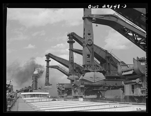 Cleveland, Ohio. Unloading a lake freighter by means of Hewlett [i.e., Hulett] unloaders at the Pennsylvania Railroad iron ore docks