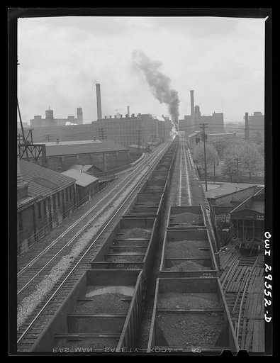 Untitled photo, possibly related to: Cleveland, Ohio. A trainlaod of iron ore leaving the Pennsylvania Railroad docks for the steel mills