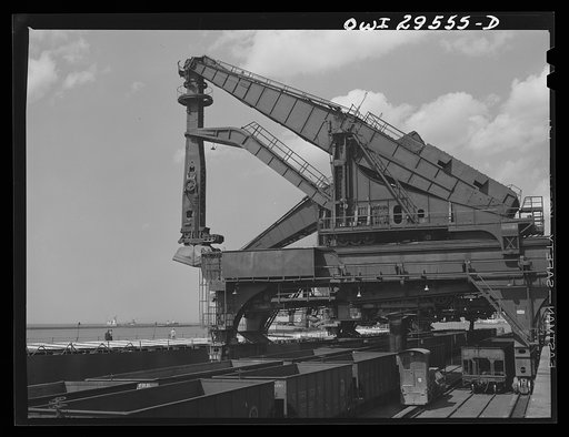 Cleveland, Ohio, Unloading a lake freighter at the Pennsylvania Railroad iron ore docks by means of Hewlett [i.e., Hulett] unloaders to pick up their loads