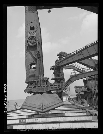 Untitled photo, possibly related to: Cleveland, Ohio. Unloading a lake freighter by means of Hewlett [i.e., Hulett] unloaders at the Pennsylvania Railroad iron ore docks