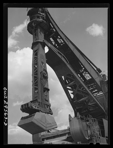 Cleveland, Ohio. Unloading a lake freighter by means of Hewlett [i.e., Hulett] unloaders at the Pennsylvania Railroad iron ore docks
