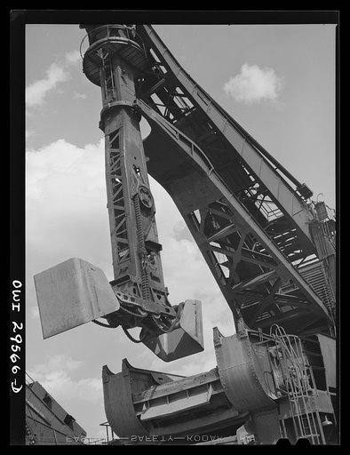 Cleveland, Ohio. Unloading a lake freighter by means of Hewlett [i.e., Hulett] unloaders at the Pennsylvania Railroad iron ore docks