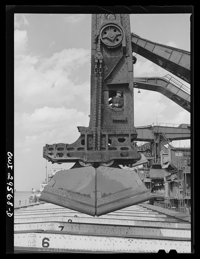 Untitled photo, possibly related to: Cleveland, Ohio. Unloading a lake freighter by means of Hewlett [i.e., Hulett] unloaders at the Pennsylvania Railroad iron ore docks