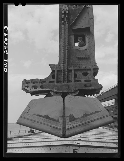 Cleveland, Ohio. Unloading a lake freighter by means of Hewlett [i.e., Hulett] unloaders at the Pennsylvania Railroad iron ore docks