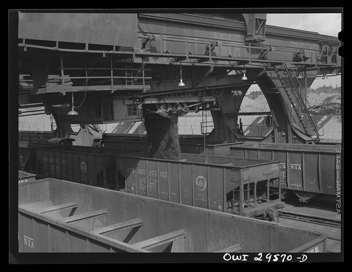 Cleveland, Ohio. Iron ore dropping from Hewlett [i.e., Hulett] unloaders into the hopper cars at the Pennsylvania Railroad docks