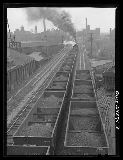 Untitled photo, possibly related to: Cleveland, Ohio. On the left, a Pennsylvania Railroad iron ore train about to leave for the steel mills; right, a Pennsylvania Railroad train is coming in from the coal mines