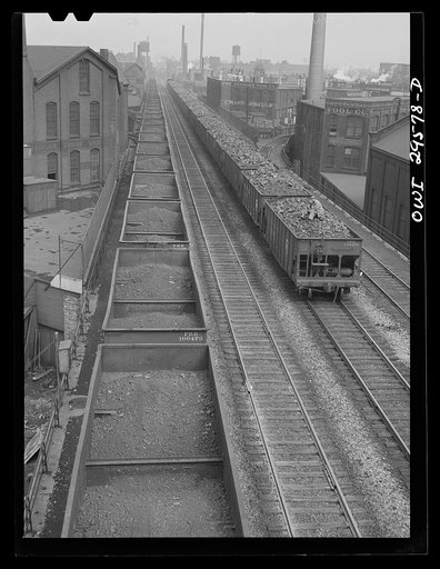 Cleveland, Ohio. On the left, a Pennsylvania Railroad iron ore train about to leave for the steel mills; right, a Pennsylvania Railroad train is coming in from the coal mines